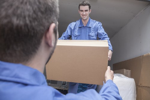 Professional movers loading household items into a truck