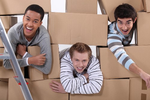 Packed boxes and furniture ready for loading into a van