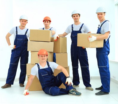 Professional movers beginning a careful relocation process with packed boxes