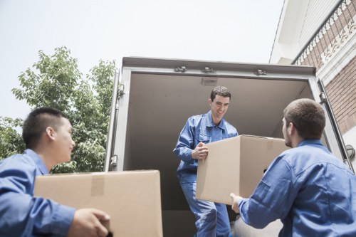 Furniture pick-up service removing a sofa from a local home in To
