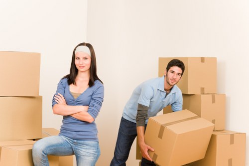 Packed office equipment and labelled boxes ready for transport during a commercial relocation