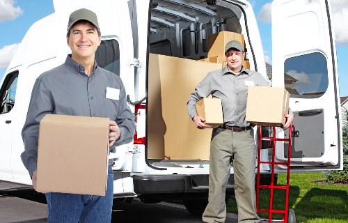 Commercial removals setup with office furniture and equipment ready for transport in To