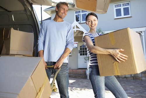 Local movers handling fragile items and labeled boxes in To