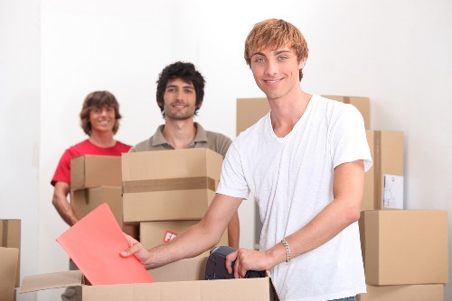 Loading furniture into a moving van for a local customer